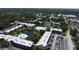 Aerial view of a condo complex featuring a central pond, fountain, and community pool at 14130 Rosemary Ln # 3202, Largo, FL 33774