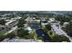 A serene aerial view showcases condos with a central pond, swaying trees, and a pool, blending nature and relaxation at 14130 Rosemary Ln # 3202, Largo, FL 33774