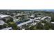 A bird's-eye view showcasing the tranquil lake, lush green trees, and sparkling pool at 14130 Rosemary Ln # 3202, Largo, FL 33774