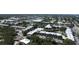 Aerial view of a condo community with a pond, fountain, parking, and nearby businesses at 14130 Rosemary Ln # 3202, Largo, FL 33774