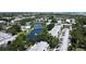 Overhead view showcasing community pool, pond, bridge, and lush landscaping at 14130 Rosemary Ln # 3202, Largo, FL 33774
