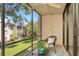 Inviting screened balcony featuring a ceiling fan and relaxing views of the lush landscape at 14130 Rosemary Ln # 3202, Largo, FL 33774
