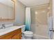 Neutral bathroom includes shower with built in seat, handrails, and a wooden vanity at 14130 Rosemary Ln # 3202, Largo, FL 33774