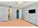 Bedroom with wooden floors, ceiling fan, access to bathroom and closet, and a modern flat screen tv at 14130 Rosemary Ln # 3202, Largo, FL 33774
