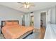 Comfortable bedroom with natural light, wood floor and ceiling fan plus access to ensuite bathroom at 14130 Rosemary Ln # 3202, Largo, FL 33774