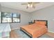 Nicely lit bedroom with hardwood floors, ceiling fan and a large window overlooking the complex at 14130 Rosemary Ln # 3202, Largo, FL 33774