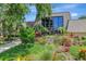 Exterior of a well-maintained clubhouse with vibrant flowers and greenery at 14130 Rosemary Ln # 3202, Largo, FL 33774
