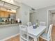 The dining area features a white table and is conveniently located next to the kitchen area at 14130 Rosemary Ln # 3202, Largo, FL 33774