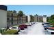 Exterior view of multi-story residential building with parking and landscaping at 14130 Rosemary Ln # 3202, Largo, FL 33774