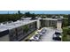 Exterior shot of the building showcasing the balcony, parking, and palm trees at 14130 Rosemary Ln # 3202, Largo, FL 33774