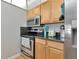 Bright kitchen features stainless steel appliances, granite countertops, and natural wood cabinets at 14130 Rosemary Ln # 3202, Largo, FL 33774