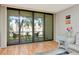 Bright living room featuring sliding glass doors to the screened balcony and beautiful hardwood floors at 14130 Rosemary Ln # 3202, Largo, FL 33774