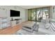Inviting living room with sliding glass doors to the balcony, a plush sofa, and stylish furnishings at 14130 Rosemary Ln # 3202, Largo, FL 33774