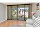 Cozy living room features sliding glass doors and hardwood floors at 14130 Rosemary Ln # 3202, Largo, FL 33774