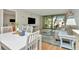 The living room with a sliding glass door leads to the lanai and fills the space with natural light at 14130 Rosemary Ln # 3202, Largo, FL 33774