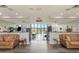 Inviting lobby area with comfortable leather seating and view of the large event room with lots of natural light at 14130 Rosemary Ln # 3202, Largo, FL 33774
