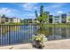 Serene view of the community pond with a fountain, lush greenery, and inviting building exteriors at 14130 Rosemary Ln # 3202, Largo, FL 33774