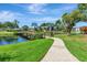 Scenic walkway leading to a wooden bridge over a serene pond with lush surroundings at 14130 Rosemary Ln # 3202, Largo, FL 33774