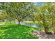 Picturesque pond featuring a fountain, mature trees, ducks, and plenty of shade at 14130 Rosemary Ln # 3202, Largo, FL 33774