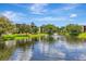 Serene pond view reflecting the sky and surrounding buildings, creating a peaceful ambiance at 14130 Rosemary Ln # 3202, Largo, FL 33774