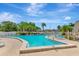 Large community pool with multiple lounge chairs and well-maintained pool deck at 14130 Rosemary Ln # 3202, Largo, FL 33774