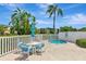 Inviting spa area with a table, chairs, umbrella, and lush landscaping at 14130 Rosemary Ln # 3202, Largo, FL 33774
