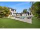 Spacious backyard with inviting pool, outdoor seating, and verdant lawn at 1650 22Nd N Ave, St Petersburg, FL 33713