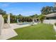 Inviting backyard featuring a pool, putting green, outdoor kitchen, and verdant landscape at 1650 22Nd N Ave, St Petersburg, FL 33713