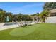 Expansive backyard with an in-ground pool, putting green, and outdoor kitchen area at 1650 22Nd N Ave, St Petersburg, FL 33713