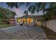 Charming home with a brick driveway, mature trees, and a carport, providing a blend of comfort and curb appeal at 1650 22Nd N Ave, St Petersburg, FL 33713