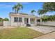 Charming single-story home with a well-manicured lawn, freshly painted with neatly trimmed palm trees at 1650 22Nd N Ave, St Petersburg, FL 33713