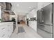 Beautiful open kitchen features stainless steel appliances, white cabinetry, and modern lighting at 1650 22Nd N Ave, St Petersburg, FL 33713