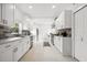 Spacious kitchen features white cabinetry, stainless appliances, and stone tile backsplash at 1650 22Nd N Ave, St Petersburg, FL 33713