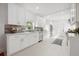 Bright, modern kitchen with white cabinets, stainless steel appliances, and tile backsplash at 1650 22Nd N Ave, St Petersburg, FL 33713