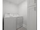Bright laundry room featuring a white washer and dryer, next to extra cabinet storage at 1650 22Nd N Ave, St Petersburg, FL 33713
