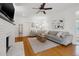 Bright living room featuring hardwood floors, a comfortable seating arrangement, and a stylish brick fireplace at 1650 22Nd N Ave, St Petersburg, FL 33713