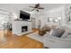 Bright living room featuring hardwood floors, a brick fireplace, and a comfortable seating arrangement, creating a cozy atmosphere at 1650 22Nd N Ave, St Petersburg, FL 33713
