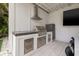 Stainless steel outdoor kitchen with a grill, range hood, refrigerator and storage, ideal for outdoor cooking at 1650 22Nd N Ave, St Petersburg, FL 33713