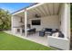 Outdoor living space featuring a grill, TV, dining area, and a cozy seating area for entertaining at 1650 22Nd N Ave, St Petersburg, FL 33713