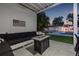 Inviting outdoor lounge area with comfortable seating, a fire pit, and serene views of the pool at 1650 22Nd N Ave, St Petersburg, FL 33713