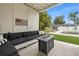 Outdoor seating area with a comfortable sofa, fire table, and views of the pool and well-maintained yard at 1650 22Nd N Ave, St Petersburg, FL 33713