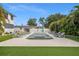 Backyard pool and lounging area, surrounded by a white fence, artificial turf and tropical plants at 1650 22Nd N Ave, St Petersburg, FL 33713