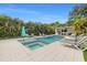Inviting pool area with lounge chairs, lush landscaping, and an outdoor kitchen, perfect for relaxation and entertaining at 1650 22Nd N Ave, St Petersburg, FL 33713