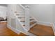 Bright, freshly painted staircase features hardwood treads and white risers and stringers at 1650 22Nd N Ave, St Petersburg, FL 33713