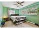 Green bedroom with bed, carpet flooring, and natural light, creating a peaceful and relaxing retreat at 1707 Cardinal Dr, Clearwater, FL 33759