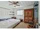 Bedroom with carpet flooring, ceiling fan, and natural light; showcases an inviting and comfortable atmosphere at 1707 Cardinal Dr, Clearwater, FL 33759