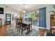 Elegant dining room with hardwood floors, modern lighting, and access to the patio at 1707 Cardinal Dr, Clearwater, FL 33759