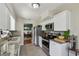 Modern kitchen with white cabinets, granite countertops, and stainless steel appliances at 1707 Cardinal Dr, Clearwater, FL 33759