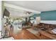 Spacious living room with hardwood floors, a ceiling fan, and sliding glass doors to the patio at 1707 Cardinal Dr, Clearwater, FL 33759