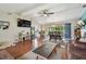 Open-concept living area with hardwood floors, and a view of the dining area and patio at 1707 Cardinal Dr, Clearwater, FL 33759